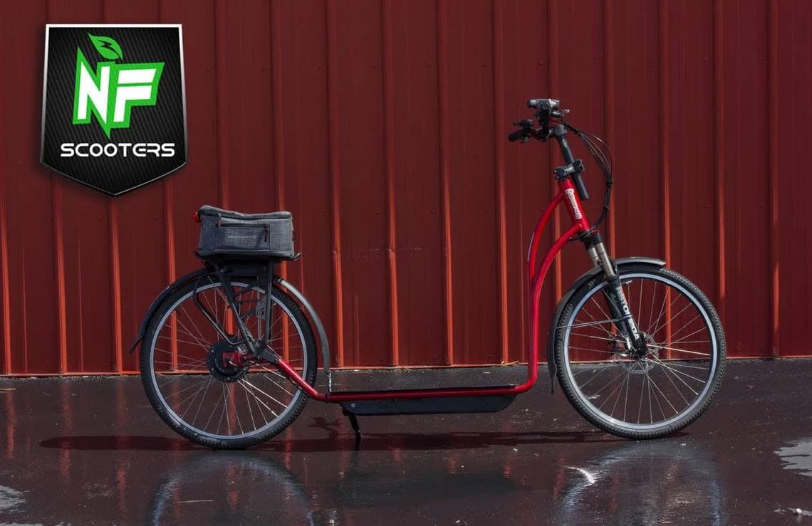 Red NF scooter from 2017 against a red wall