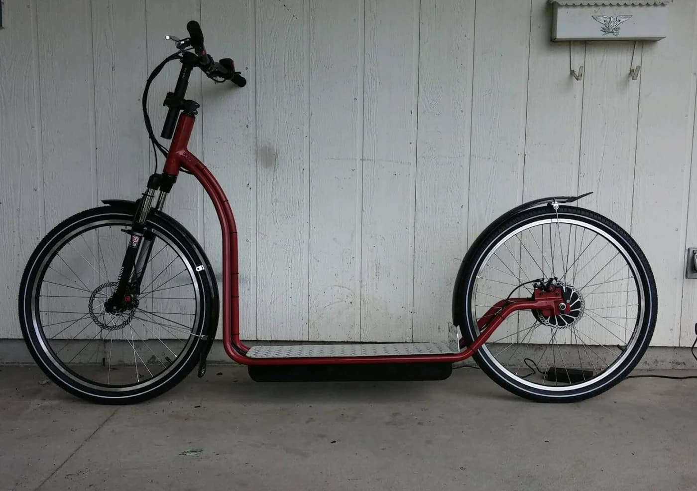 Red frame of an early NF scooter in side profile